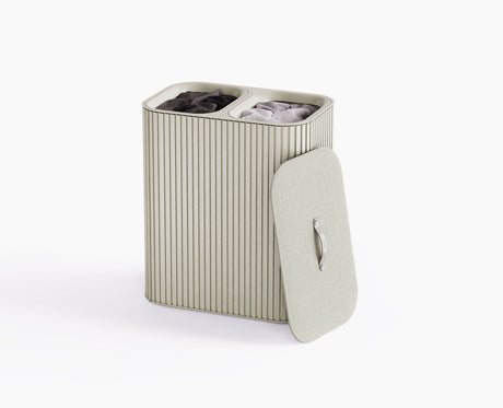 Joseph Joseph Tota Luxe 90L laundry basket in ecru with bamboo exterior and closed fabric-wrapped lid.