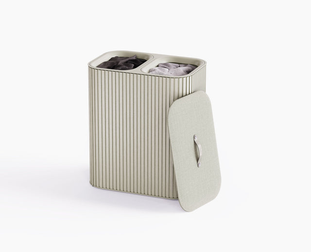 Joseph Joseph Tota Luxe 90L laundry basket in ecru with bamboo exterior and closed fabric-wrapped lid.