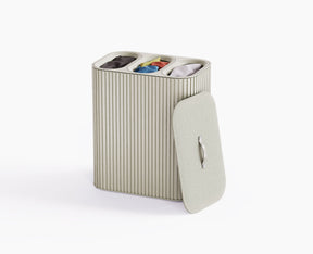 Joseph Joseph Tota Trio Luxe 90L laundry basket in ecru with the bamboo exterior and lid closed.