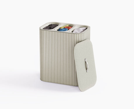 Joseph Joseph Tota Trio Luxe 90L laundry basket in ecru with the bamboo exterior and lid closed.