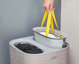 The grey Tota basket with its lid off, showing two 30-litre tote bags inside.