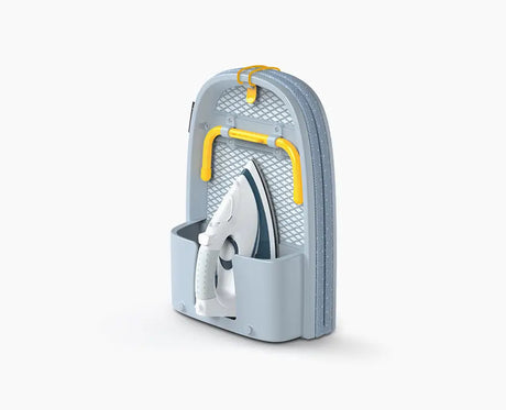 Joseph Joseph Pocket folding ironing board in grey, open on a table top.