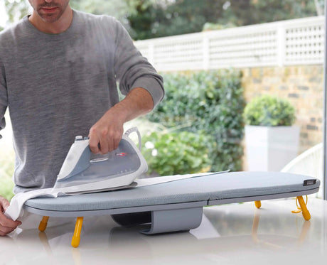 Iron stored inside the board's integrated compartment before folding.