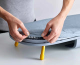 Wall bracket holding the folded Pocket ironing board against a wall.
