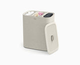 Joseph Joseph Tota Trio 90L laundry basket in ecru with the lid in place.