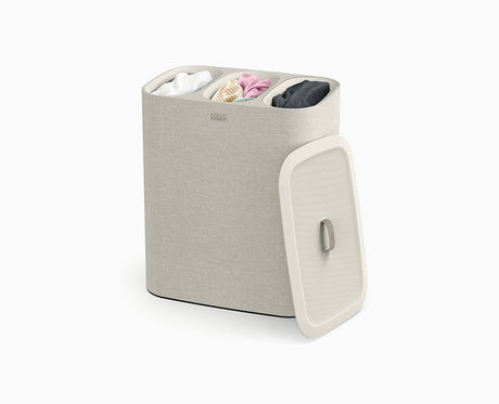 Joseph Joseph Tota Trio 90L laundry basket in ecru with the lid in place.