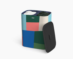 Joseph Joseph Tota 90L laundry basket in the Jonathan Lawes multicolour print with the lid on.