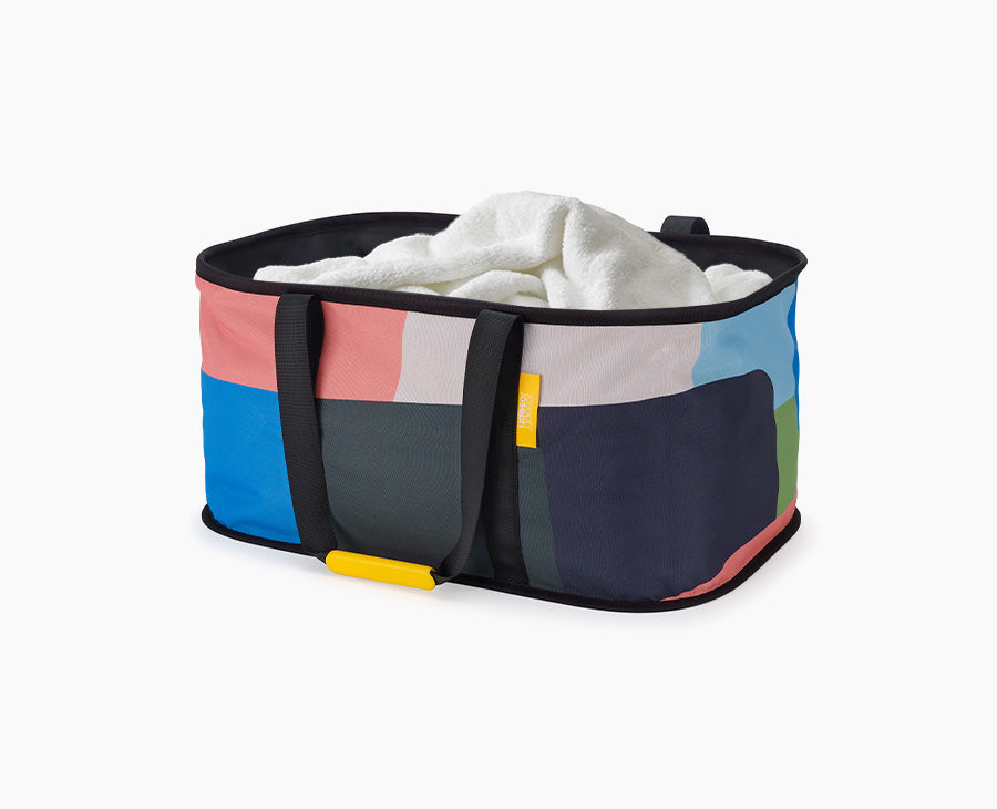 Joseph Joseph Hold-All 35L collapsible laundry basket in the Jonathan Lawes multicolour print.