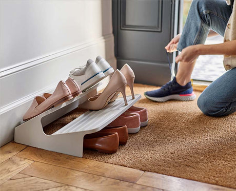 The tiered ecru rack holding six pairs of shoes at once.