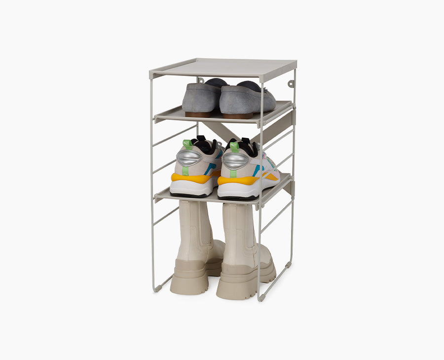Joseph Joseph Level adjustable shoe rack in ecru on its steel frame.