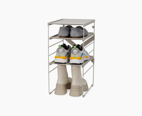 Joseph Joseph Level adjustable shoe rack in ecru on its steel frame.
