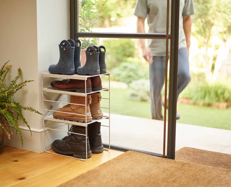 Shelf being clipped onto the steel frame at a different height.