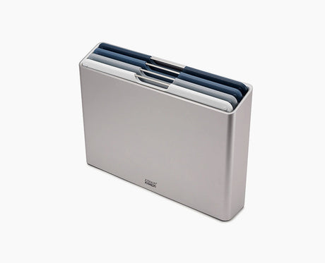 Joseph Joseph Folio Editions four-piece chopping board set in blue, boards stacked in the slimline case.