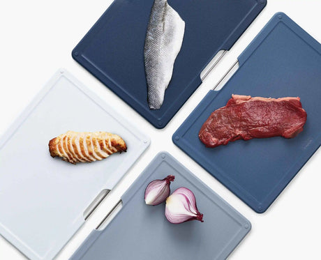 Folio board set standing on a kitchen worktop beside food preparation.