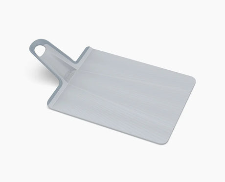 Joseph Joseph Chop2Pot Plus large folding chopping board in blue, laid flat.