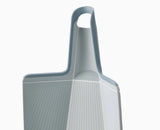 The blue Chop2Pot board resting on a kitchen worktop during food preparation.