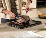 Close-up of the integrated meat-grip spikes holding a joint steady.