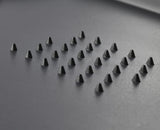 The black extra-large board in use on a kitchen worktop.