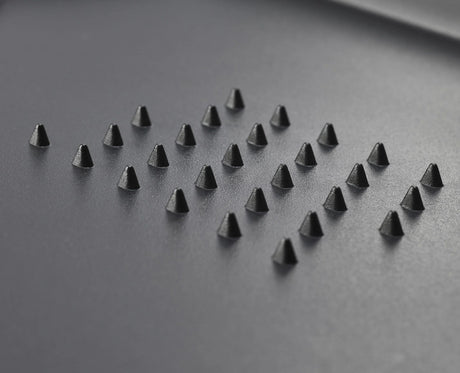 The black extra-large board in use on a kitchen worktop.