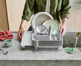 Joseph Joseph Extend Steel Plus expandable dish rack in stone fully expanded with dishes, Homelux Kenya