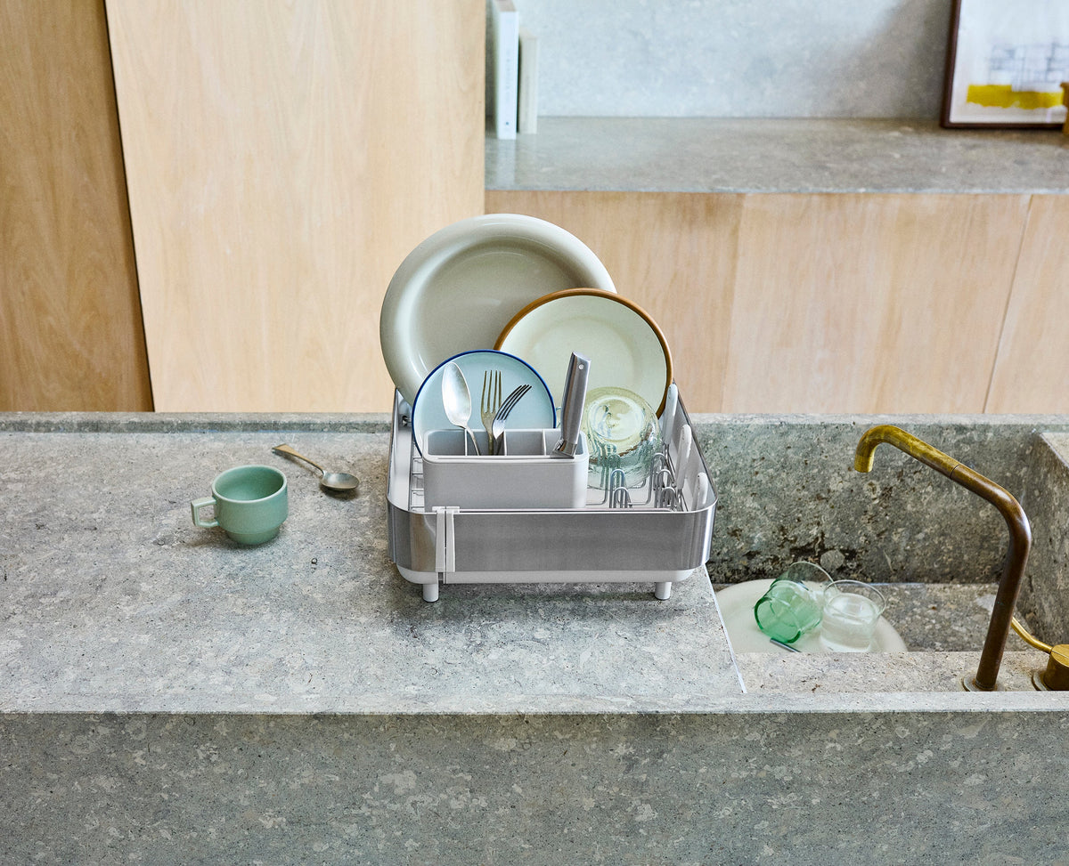 Joseph Joseph Extend Steel Plus expandable dish rack in stone rail folded down to drain bottles, Homelux Kenya