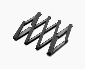 Joseph Joseph Stretch expandable trivet in black, opened out to full size.