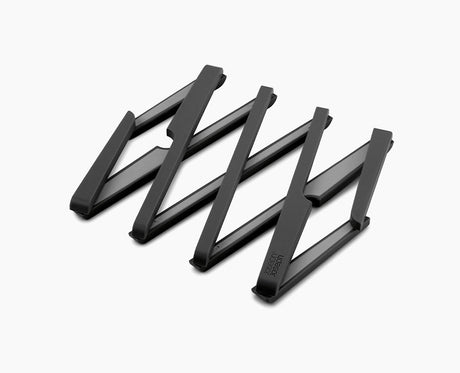Joseph Joseph Stretch expandable trivet in black, opened out to full size.