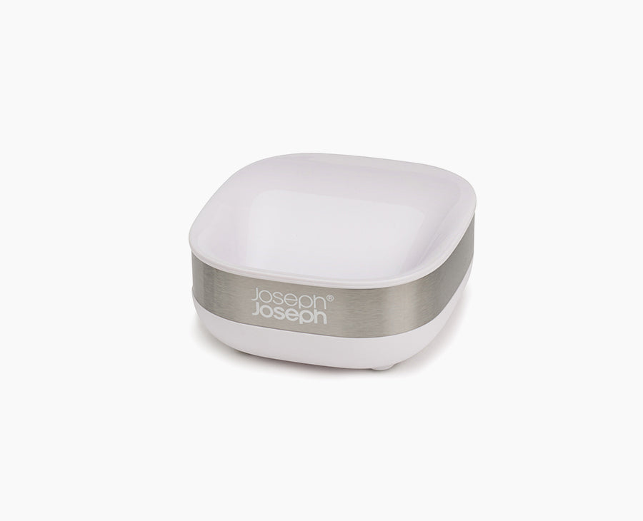 Joseph Joseph Slim compact stainless-steel soap dish in white, holding a bar of soap.
