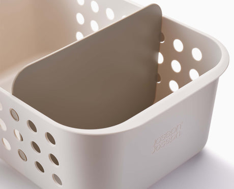 The basket stored on a bathroom shelf alongside other essentials.