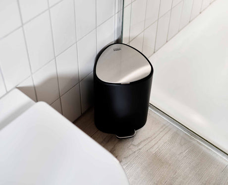 Joseph Joseph EasyStore 5L bin fitted snugly into a bathroom corner