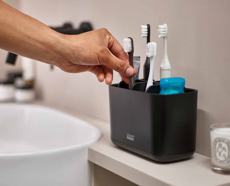 The large matt black caddy on a family bathroom basin.