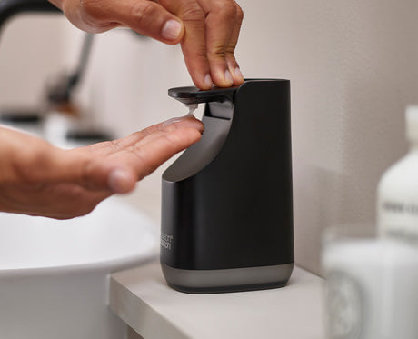 Joseph Joseph Slim Compact soap pump in matt black beside a bathroom basin, Homelux Kenya