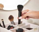 Deep compartments holding make-up brushes, mascara and eyeliner pencils.