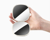 The soft silicone strap used as a finger loop to hold the mirror securely.