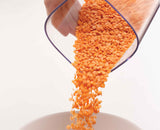 The set filled with dry foods and standing on a kitchen worktop.