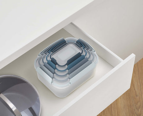 The Editions set stacked on a kitchen shelf.