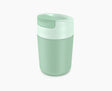 Joseph Joseph Sipp travel mug in green with the flip-top lid closed.