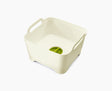 Joseph Joseph Wash and Drain washing-up bowl in white and green, shown from above.