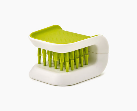 Joseph Joseph BladeBrush knife cleaning brush in green, seen from the side.