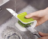 The BladeBrush wrapped around a knife blade, cleaning both sides at once.