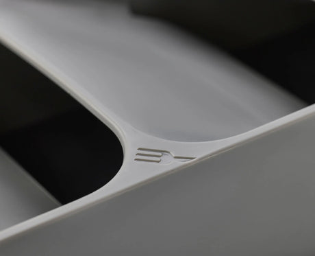A hand lifting a fork from the top tier of the grey cutlery organiser.