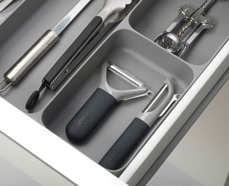 The organiser installed in an open kitchen drawer with everything sorted in place.