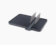 Joseph Joseph Flip-Up draining board in grey with the plate rack raised.