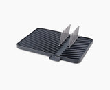 Joseph Joseph Flip-Up draining board in grey with the plate rack raised.
