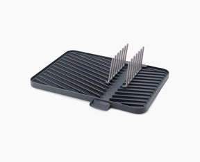 Joseph Joseph Flip-Up draining board in grey with the plate rack raised.