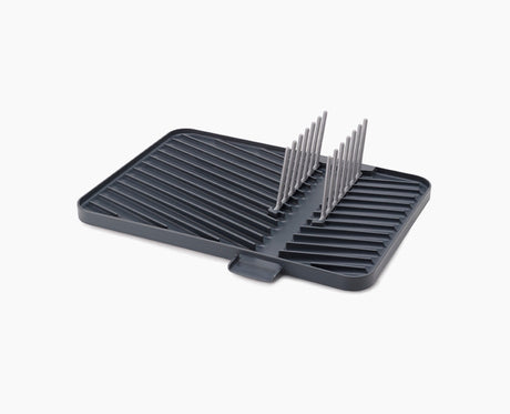 Joseph Joseph Flip-Up draining board in grey with the plate rack raised.