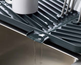 Close-up of the draining spout directing water back into the sink.