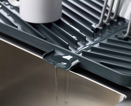 Close-up of the draining spout directing water back into the sink.