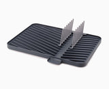 The rack part-folded, showing how it collapses down onto the flat draining surface.