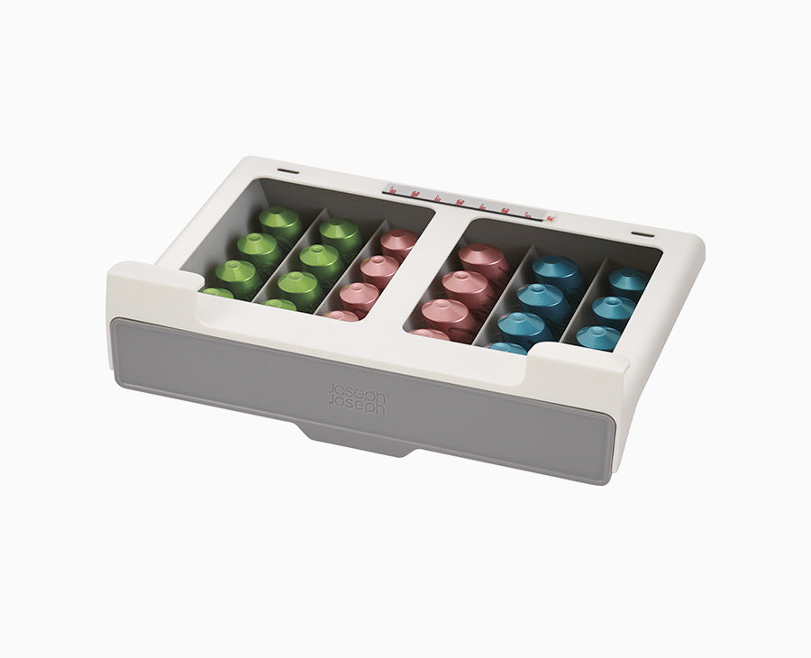 Joseph Joseph CupboardStore under-shelf coffee pod drawer in grey, filled with coffee pods.